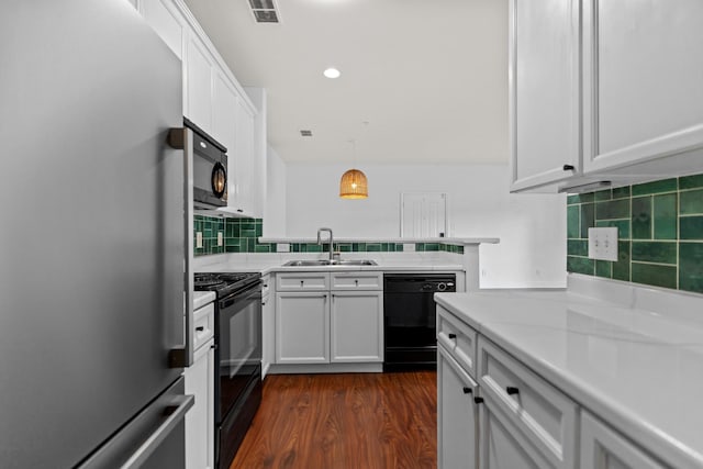 8441 Callabee Way # 14, Antioch, TN 37013 - kitchen with black appliances, light countertops, white cabinets, tasteful backsplash, and dark wood-style floors
