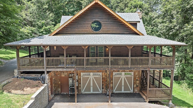 1455 Shell Rd, Goodlettsville, TN 37072 - view of front facade featuring a shingled roof, an attached garage, asphalt driveway, and a wooden deck