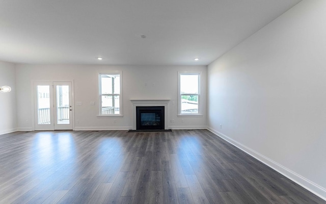 7938 Pine St, Fairview, TN 37062 - unfurnished living room featuring plenty of natural light, dark wood finished floors, a fireplace with flush hearth, and recessed lighting