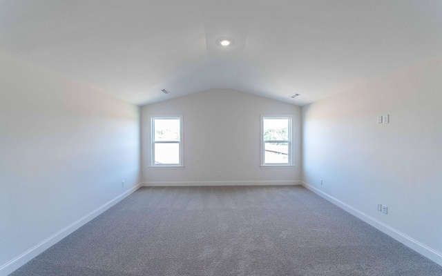 7938 Pine St, Fairview, TN 37062 - empty room with vaulted ceiling, healthy amount of natural light, and light colored carpet