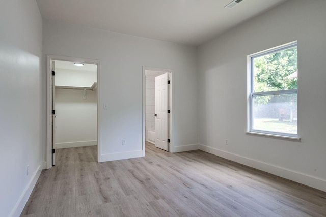 215 Kerr Ave, Murfreesboro, TN 37130 - unfurnished bedroom with light wood-style flooring, a spacious closet, ensuite bathroom, and a closet