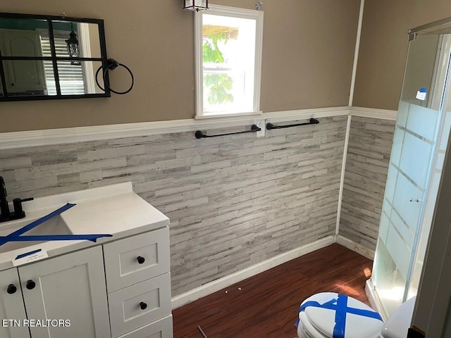 4516 Nashville Hwy, Deer Lodge, TN 37726 - bathroom with wood finished floors, vanity, wainscoting, and tile walls