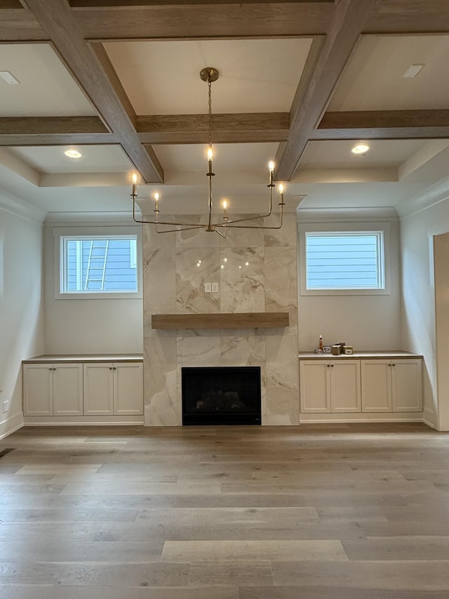 8007 Southvale Blvd, Franklin, TN 37064 - unfurnished living room with coffered ceiling, light wood finished floors, a chandelier, beam ceiling, and a fireplace