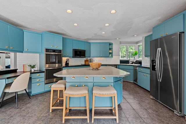 8530 Saundersville Rd, Mount Juliet, TN 37122 - kitchen featuring stainless steel appliances, a breakfast bar area, a center island, tasteful backsplash, and recessed lighting