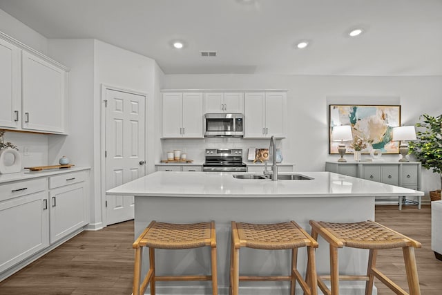2900 Suzanne Landon Dr Unit A3, Murfreesboro, TN 37130 - kitchen featuring stainless steel appliances, a kitchen breakfast bar, tasteful backsplash, dark wood finished floors, and recessed lighting