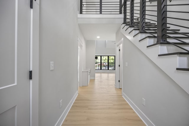 106 5th Ave N, Decherd, TN 37324 - hallway featuring light wood-style floors, stairway, recessed lighting, and a towering ceiling
