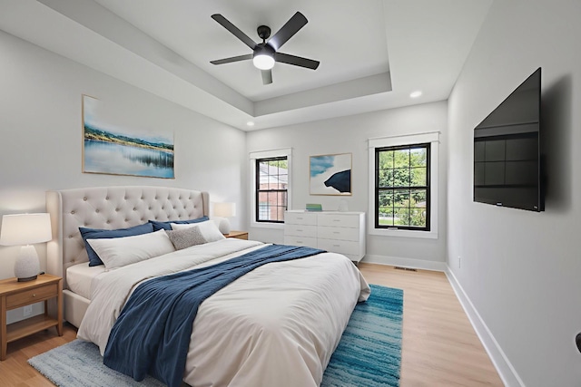 106 5th Ave N, Decherd, TN 37324 - bedroom with light wood-type flooring, a raised ceiling, a ceiling fan, and recessed lighting