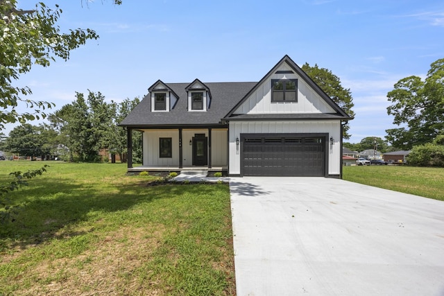 106 5th Ave N, Decherd, TN 37324 - modern farmhouse featuring a porch, concrete driveway, a front lawn, and a garage