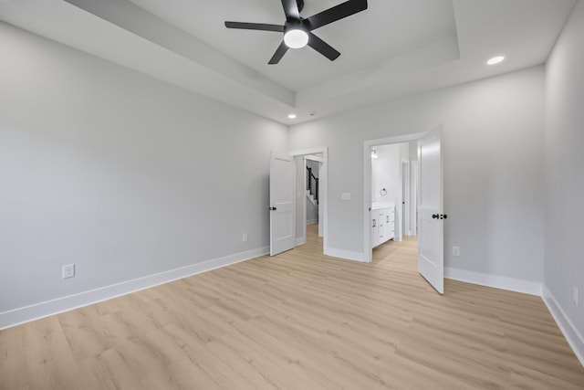 106 5th Ave N, Decherd, TN 37324 - unfurnished bedroom featuring recessed lighting, light wood-style flooring, a walk in closet, a raised ceiling, and a ceiling fan