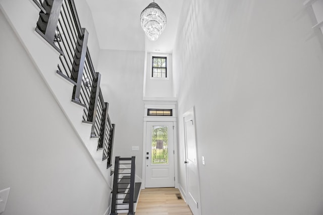 106 5th Ave N, Decherd, TN 37324 - entrance foyer with a towering ceiling, stairway, a chandelier, and light wood finished floors