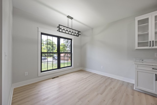 106 5th Ave N, Decherd, TN 37324 - unfurnished dining area featuring light wood-type flooring and baseboards
