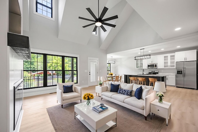 106 5th Ave N, Decherd, TN 37324 - living area featuring high vaulted ceiling, light wood-type flooring, a ceiling fan, and recessed lighting