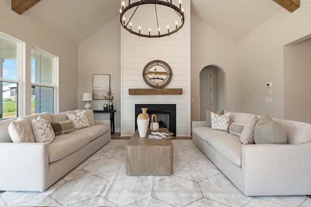 204 Phillips Bnd, Spring Hill, TN 37174 - living area featuring a chandelier, arched walkways, high vaulted ceiling, a large fireplace, and beam ceiling