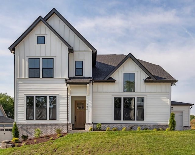 204 Phillips Bnd, Spring Hill, TN 37174 - modern farmhouse style home featuring board and batten siding, a front lawn, and a shingled roof