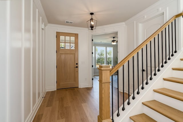 204 Phillips Bnd, Spring Hill, TN 37174 - entryway with light wood-style flooring, stairway, a ceiling fan, and crown molding