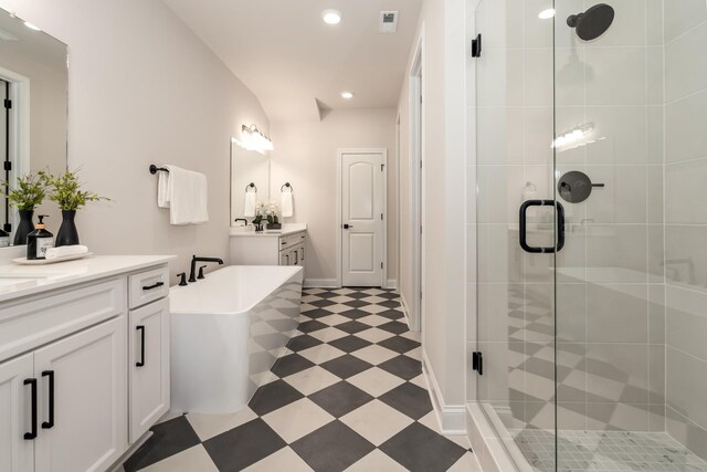 204 Phillips Bnd, Spring Hill, TN 37174 - bathroom featuring two vanities, a stall shower, a soaking tub, tile patterned floors, and recessed lighting