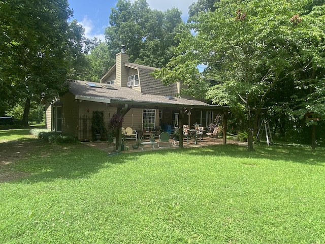3240 Valley View Ct, Goodlettsville, TN 37072 - back of house featuring a chimney, a patio, a lawn, and a shingled roof