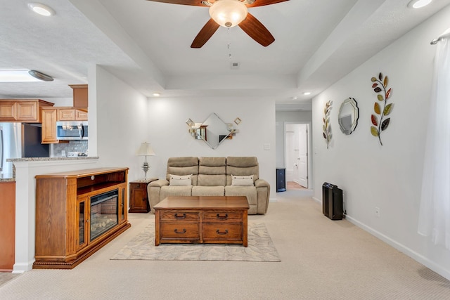 1107 Moreno Ln, Lewisburg, TN 37091 - living area with ceiling fan, light colored carpet, recessed lighting, a tray ceiling, and a glass covered fireplace