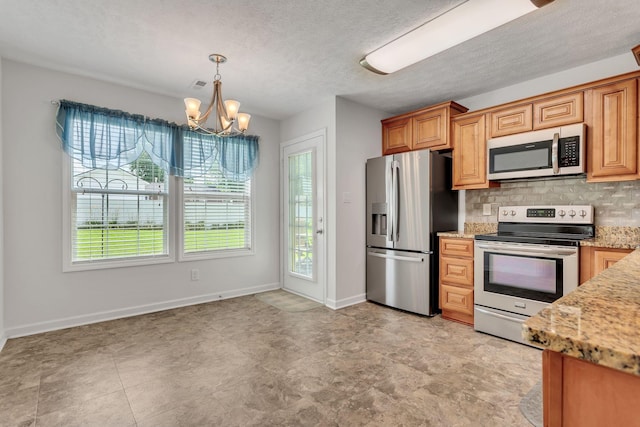 1107 Moreno Ln, Lewisburg, TN 37091 - kitchen featuring stainless steel appliances, a chandelier, tasteful backsplash, light stone counters, and pendant lighting