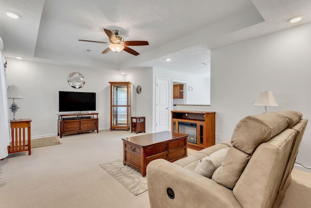 1107 Moreno Ln, Lewisburg, TN 37091 - living area with a raised ceiling, a ceiling fan, light colored carpet, a glass covered fireplace, and recessed lighting