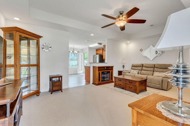 1107 Moreno Ln, Lewisburg, TN 37091 - living area with ceiling fan, a glass covered fireplace, recessed lighting, a chandelier, and a tray ceiling