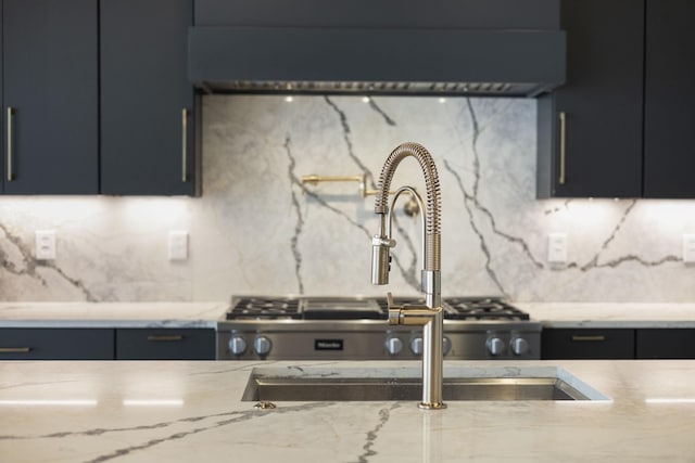 1884 Barnstaple Ln, Brentwood, TN 37027 - kitchen featuring tasteful backsplash, dark cabinetry, and light stone counters