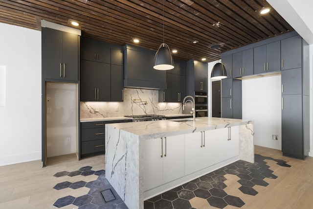 1884 Barnstaple Ln, Brentwood, TN 37027 - kitchen with range hood, light stone counters, appliances with stainless steel finishes, backsplash, and a large island