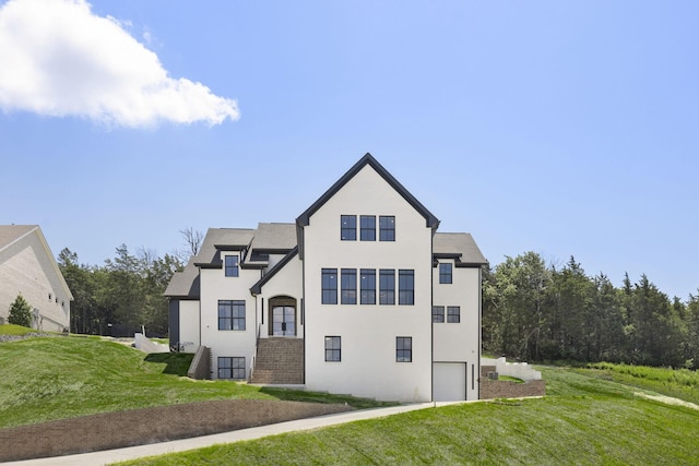 1884 Barnstaple Ln, Brentwood, TN 37027 - view of property exterior featuring an attached garage, a lawn, and stucco siding