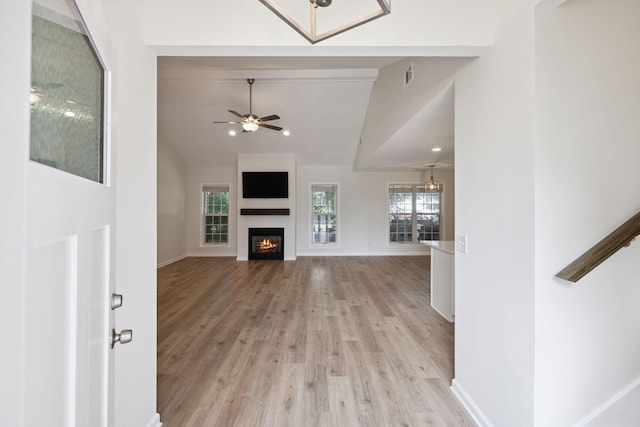 370 Calumet Trce, Murfreesboro, TN 37127 - unfurnished living room featuring light wood finished floors, vaulted ceiling, a glass covered fireplace, and a ceiling fan