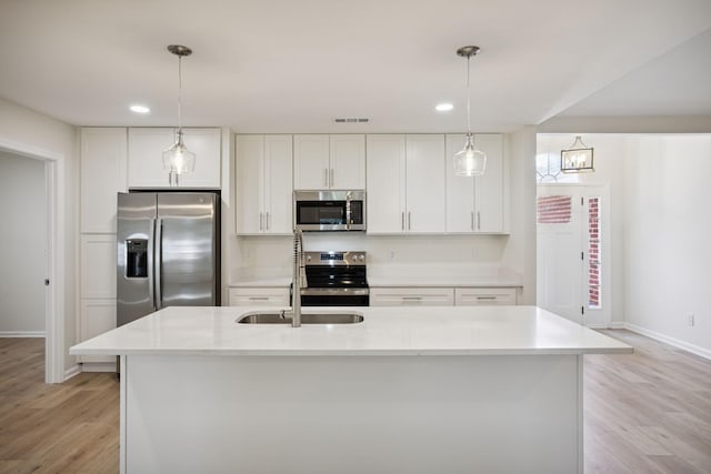 370 Calumet Trce, Murfreesboro, TN 37127 - kitchen with appliances with stainless steel finishes, light wood finished floors, white cabinets, decorative light fixtures, and recessed lighting