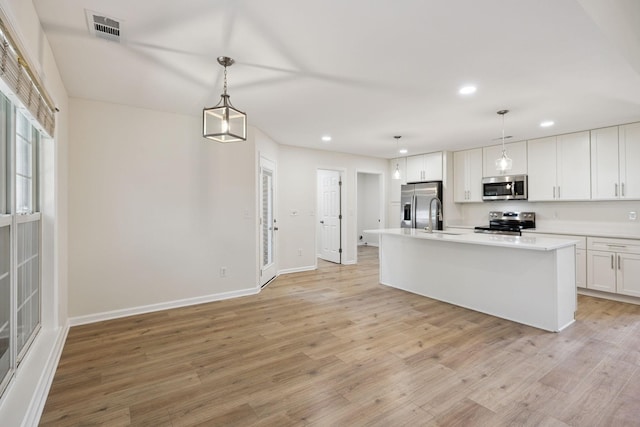 370 Calumet Trce, Murfreesboro, TN 37127 - kitchen with stainless steel appliances, recessed lighting, light countertops, light wood finished floors, and a center island with sink