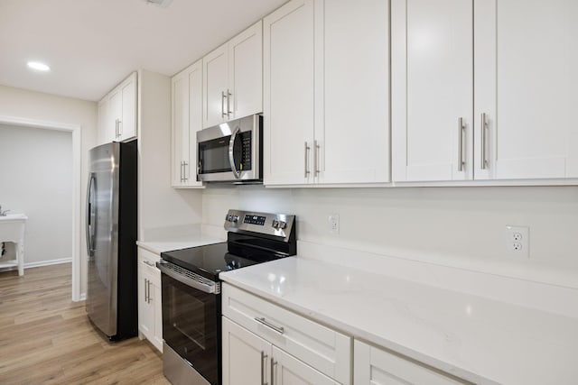 370 Calumet Trce, Murfreesboro, TN 37127 - kitchen featuring appliances with stainless steel finishes, white cabinetry, light wood-type flooring, light stone countertops, and recessed lighting