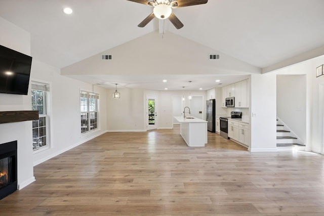 370 Calumet Trce, Murfreesboro, TN 37127 - unfurnished living room featuring a glass covered fireplace, a ceiling fan, beamed ceiling, light wood-style floors, and recessed lighting