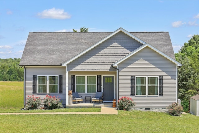 1219 Oak Grove Rd, Dickson, TN 37055 - view of front of home featuring a front yard, roof with shingles, and a porch