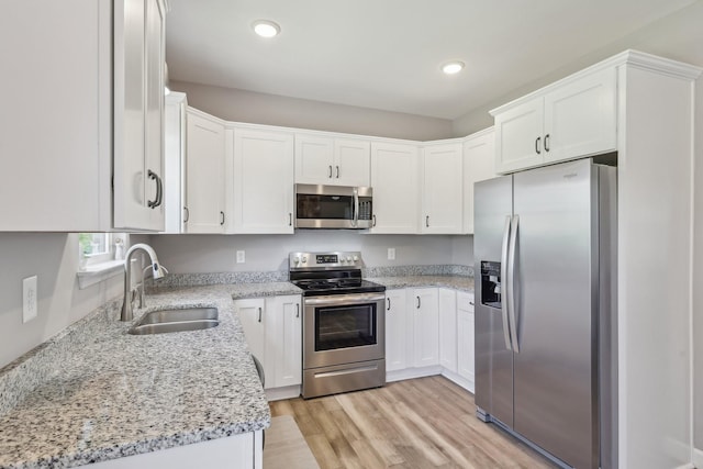 1219 Oak Grove Rd, Dickson, TN 37055 - kitchen with stainless steel appliances, light stone counters, white cabinetry, and recessed lighting