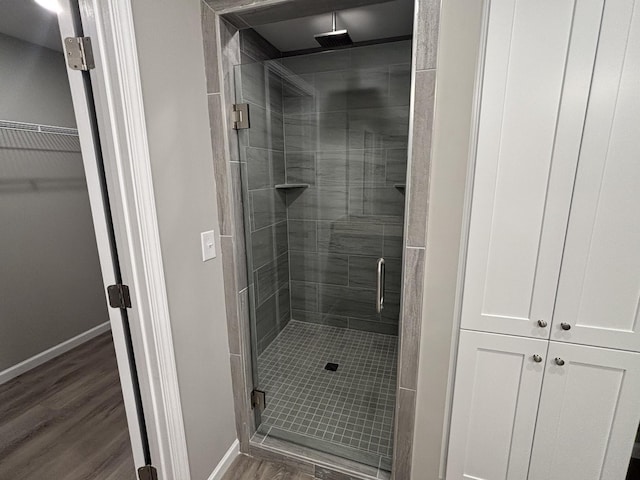 760 Hanestown Rd, Lafayette, TN 37083 - bathroom with a shower stall, wood finished floors, and a spacious closet