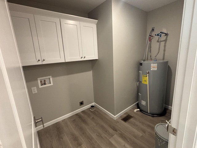 760 Hanestown Rd, Lafayette, TN 37083 - laundry room featuring water heater, hookup for a washing machine, hookup for an electric dryer, cabinet space, and wood finished floors