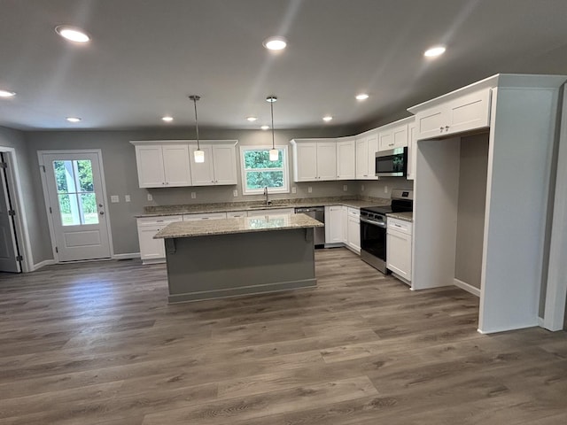 760 Hanestown Rd, Lafayette, TN 37083 - kitchen featuring appliances with stainless steel finishes, healthy amount of natural light, white cabinets, a kitchen island, and recessed lighting