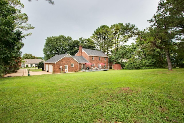201 Stoneybrook Rd, Columbia, TN 38401 - view of green lawn with a shed, driveway, and a garage