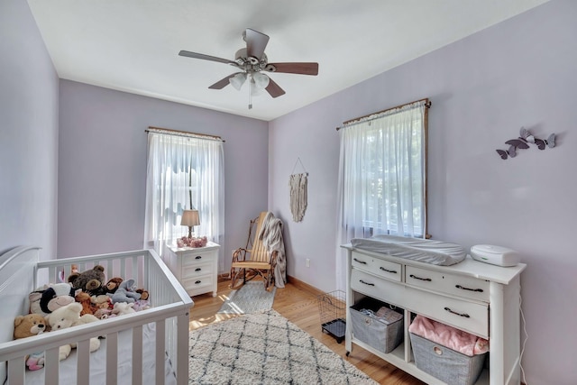 3534 Summertown Hwy, Summertown, TN 38483 - bedroom featuring a crib, light wood-style floors, and ceiling fan