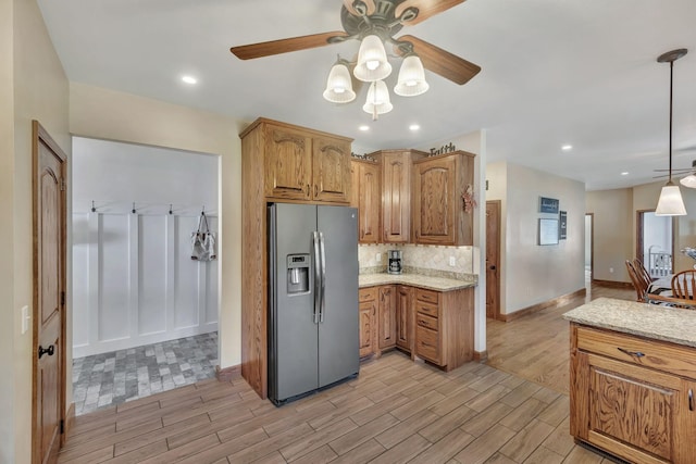 3534 Summertown Hwy, Summertown, TN 38483 - kitchen featuring stainless steel fridge, light wood finished floors, ceiling fan, light stone counters, and backsplash
