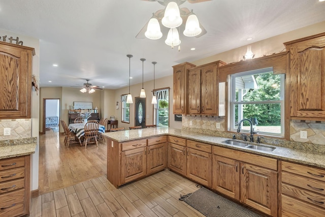 3534 Summertown Hwy, Summertown, TN 38483 - kitchen featuring a ceiling fan, a peninsula, brown cabinets, light wood-style flooring, and recessed lighting