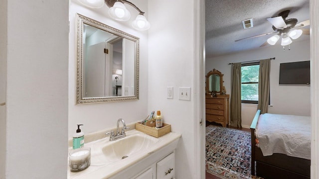 5131 Hunters Point Ln, Hermitage, TN 37076 - bathroom with vanity, a ceiling fan, and a textured ceiling