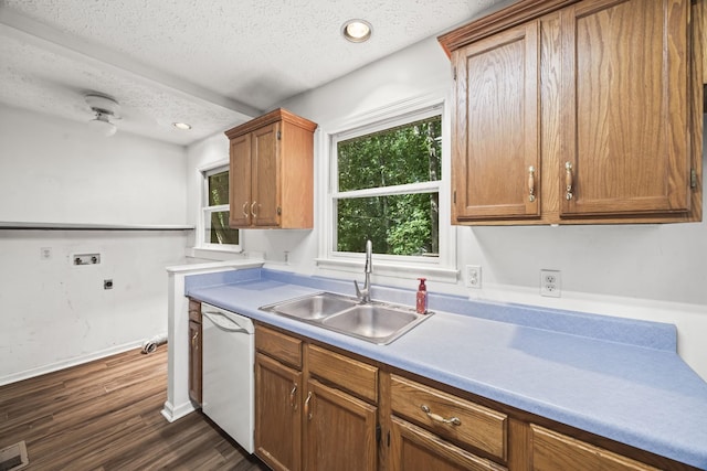7125 Sutton Pl, Fairview, TN 37062 - kitchen with white dishwasher, a textured ceiling, dark wood finished floors, brown cabinetry, and light countertops