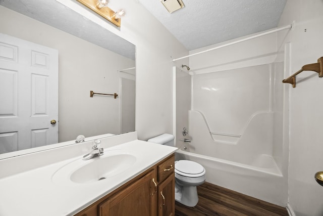 7125 Sutton Pl, Fairview, TN 37062 - bathroom with vanity, wood finished floors, shower / tub combination, and a textured ceiling