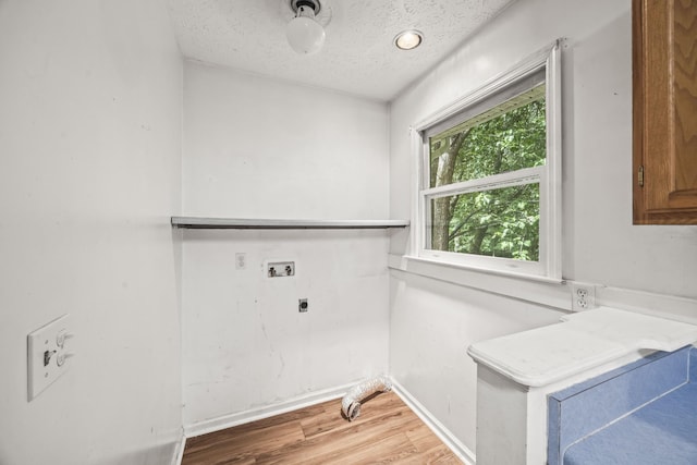 7125 Sutton Pl, Fairview, TN 37062 - laundry room featuring electric dryer hookup, a textured ceiling, light wood-type flooring, and washer hookup