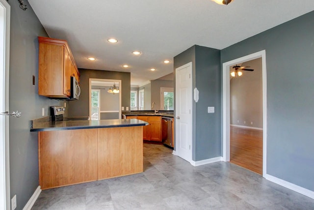 4425 Taylor Hall Ln, Adams, TN 37010 - kitchen featuring a peninsula, stainless steel appliances, dark countertops, recessed lighting, and a ceiling fan