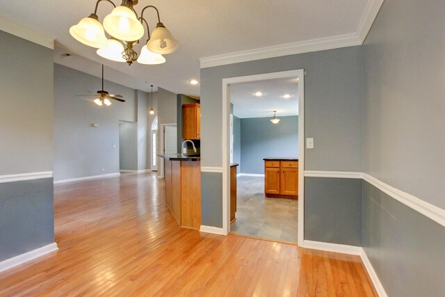 4425 Taylor Hall Ln, Adams, TN 37010 - unfurnished room featuring a chandelier, light wood finished floors, ceiling fan, ornamental molding, and vaulted ceiling
