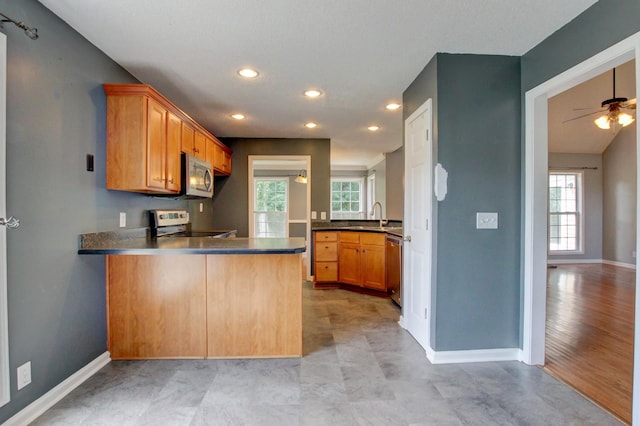 4425 Taylor Hall Ln, Adams, TN 37010 - kitchen with stainless steel appliances, a peninsula, recessed lighting, dark countertops, and a ceiling fan