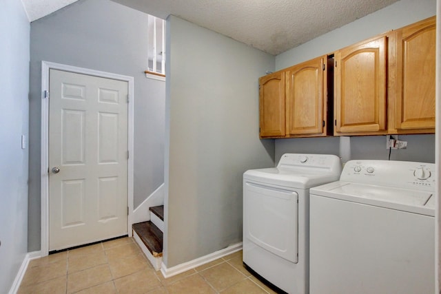 4425 Taylor Hall Ln, Adams, TN 37010 - washroom featuring washing machine and dryer, cabinet space, light tile patterned floors, and a textured ceiling